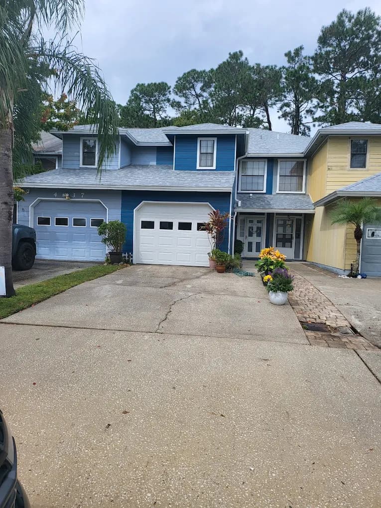 Recently painted blue house exterior with driveway